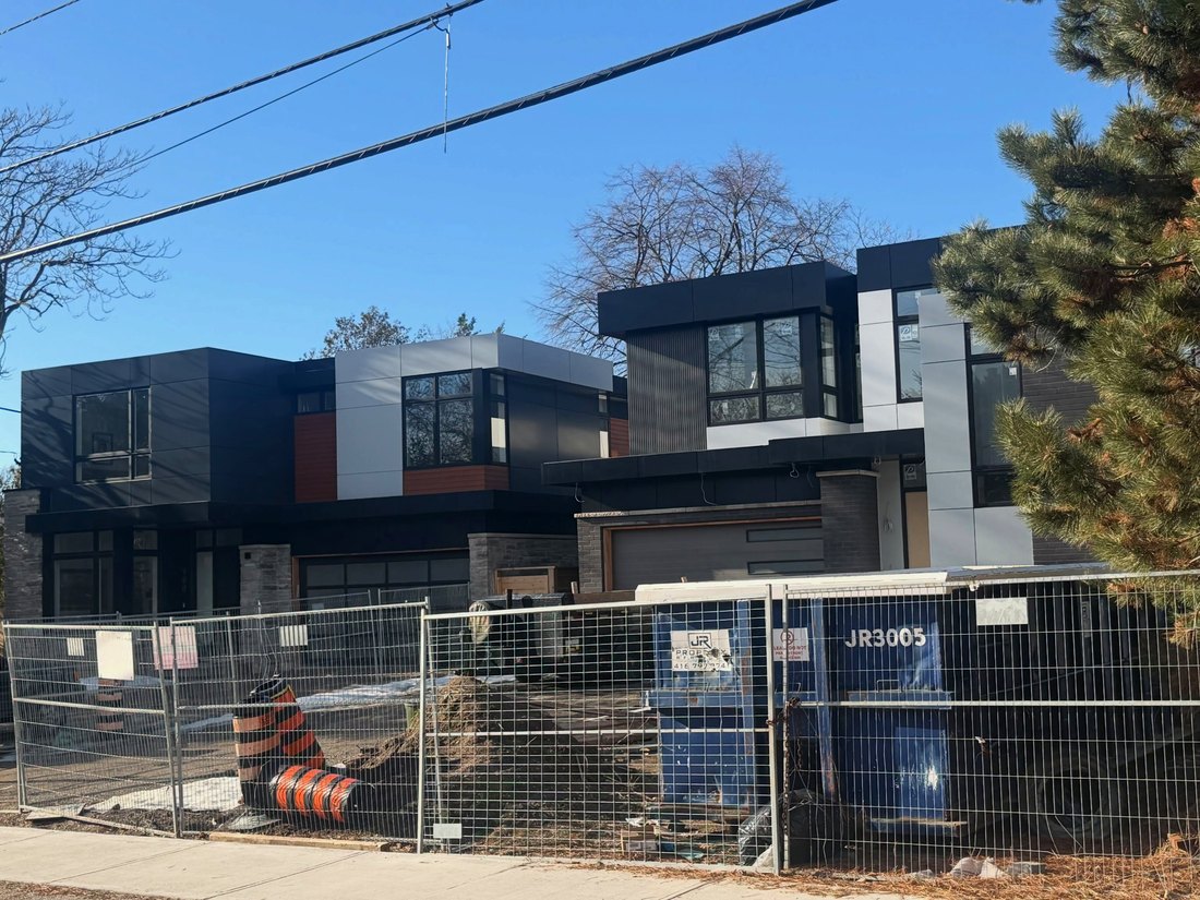 Two modern homes with dark and light exterior panel cladding, North York