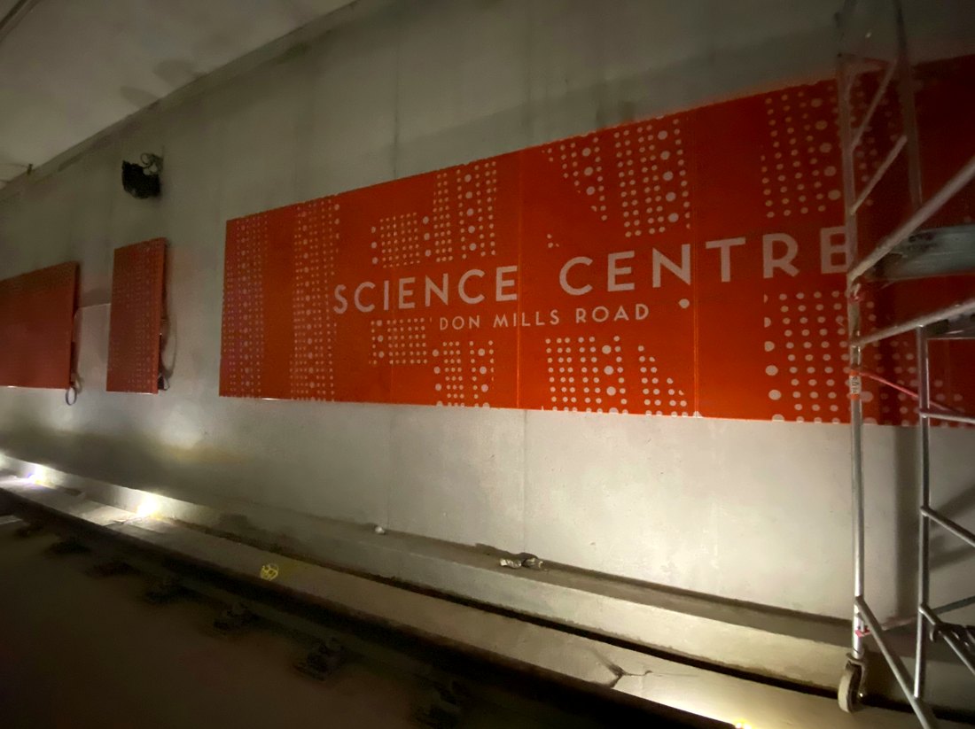 Orange Science Centre and Don Mills Road wall panels inside an Eglinton Crosstown station