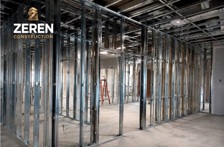Steel stud partitions framed out across an open commercial floor before boarding