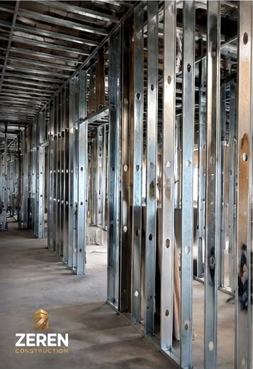 Steel stud framing running the length of a commercial corridor