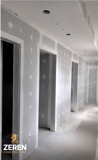 Boarded and taped partitions with door openings formed